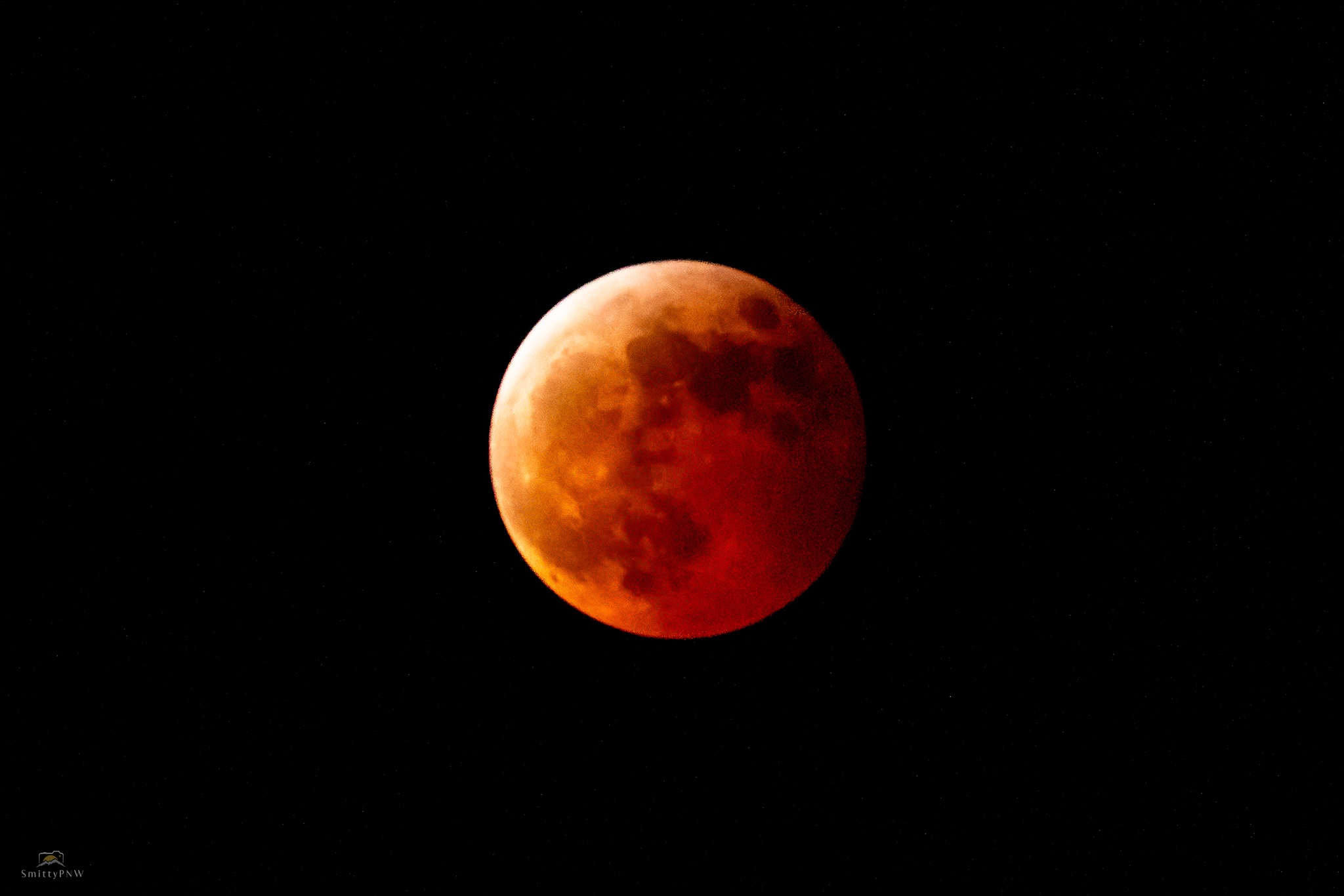 Detailed red lunar eclipse against a dark sky